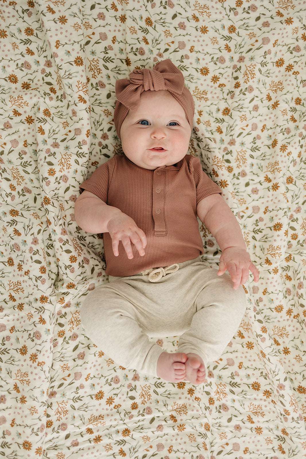 Baby Onesie Organic Cotton Ribbed Short Sleeve in dusty rose on a baby, styled with a matching headband.