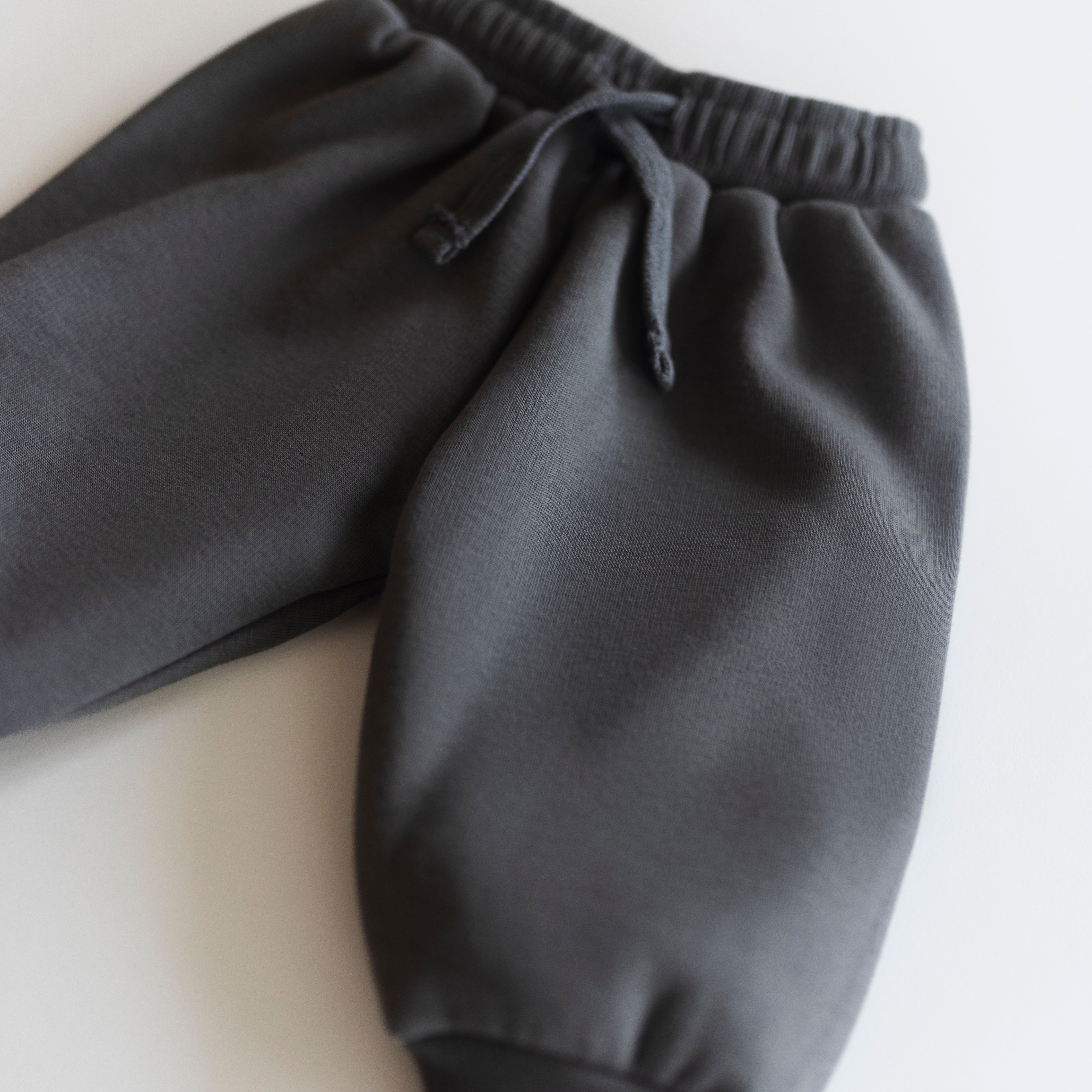 Oversized Sweatpant - cozy neutral bottoms for babies and kids in dark gray fabric.