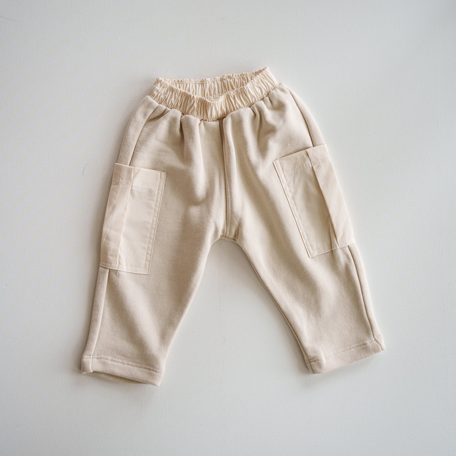 Cargo Wideleg Pant - Relaxed neutral bottoms with utility pockets and elastic waistband.