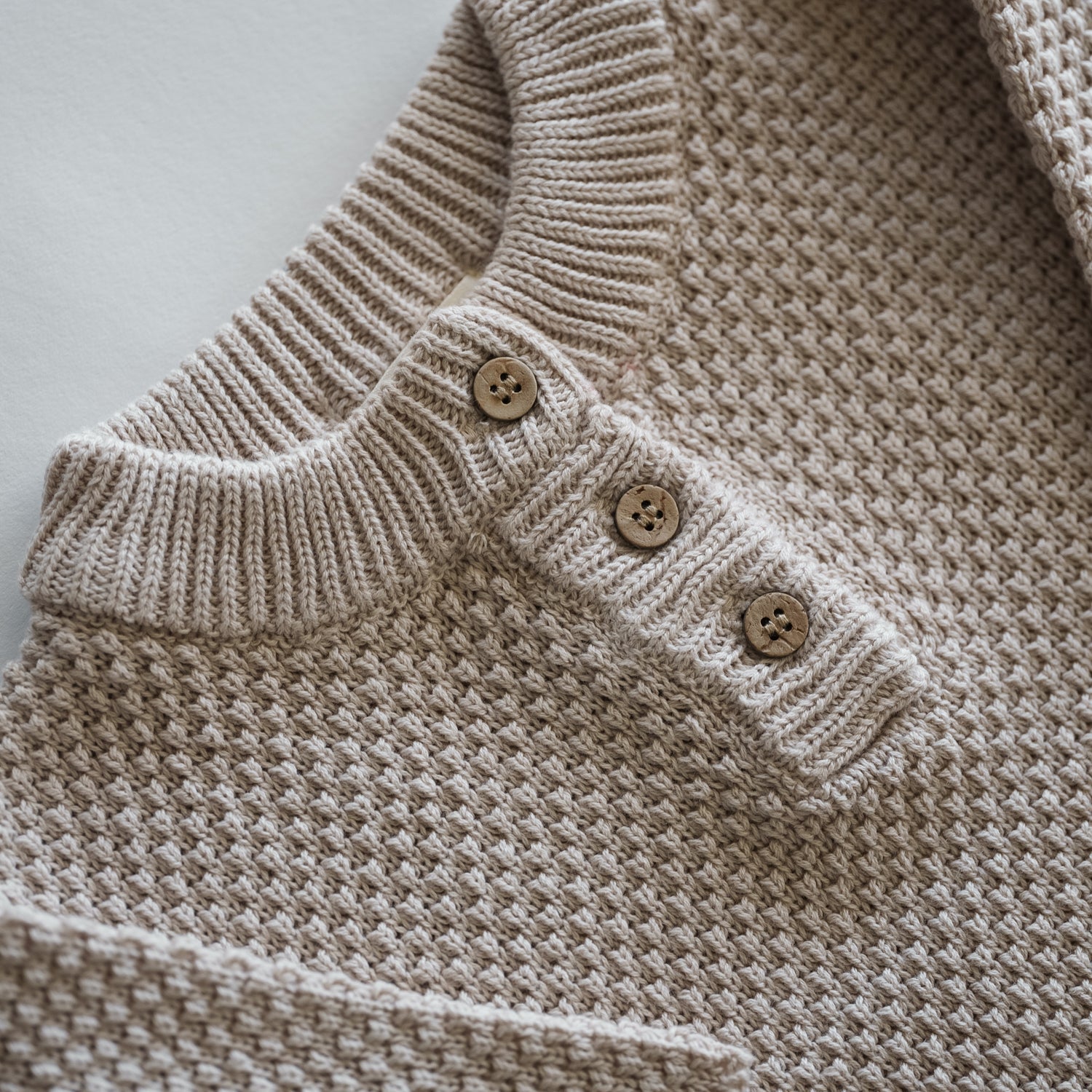 Organic Knit Baggy Longsleeve in neutral beige with textured waffle knit and wooden buttons