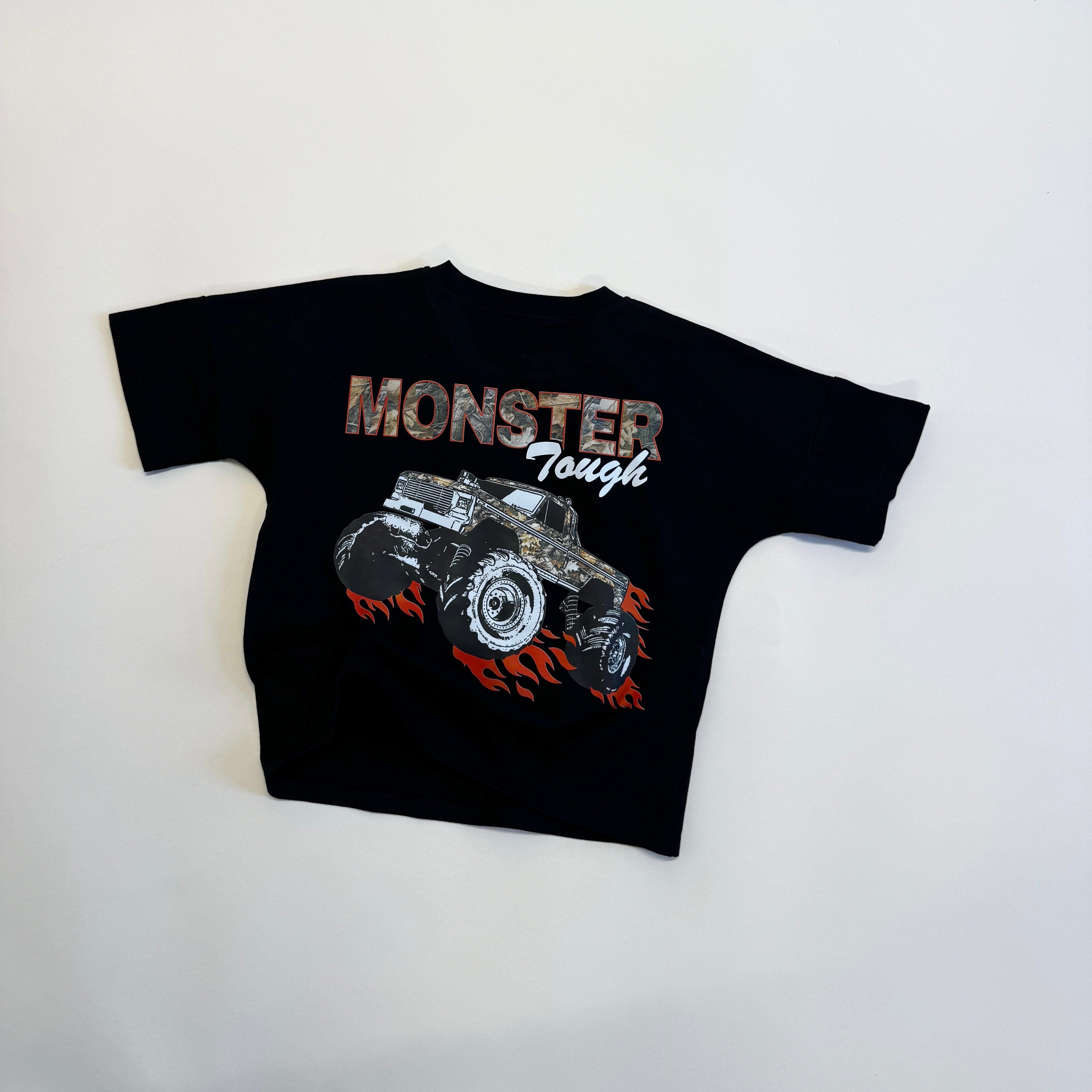 Monster truck graphic t-shirt for kids featuring bold art and the text 'MONSTER Tough' on a black background.