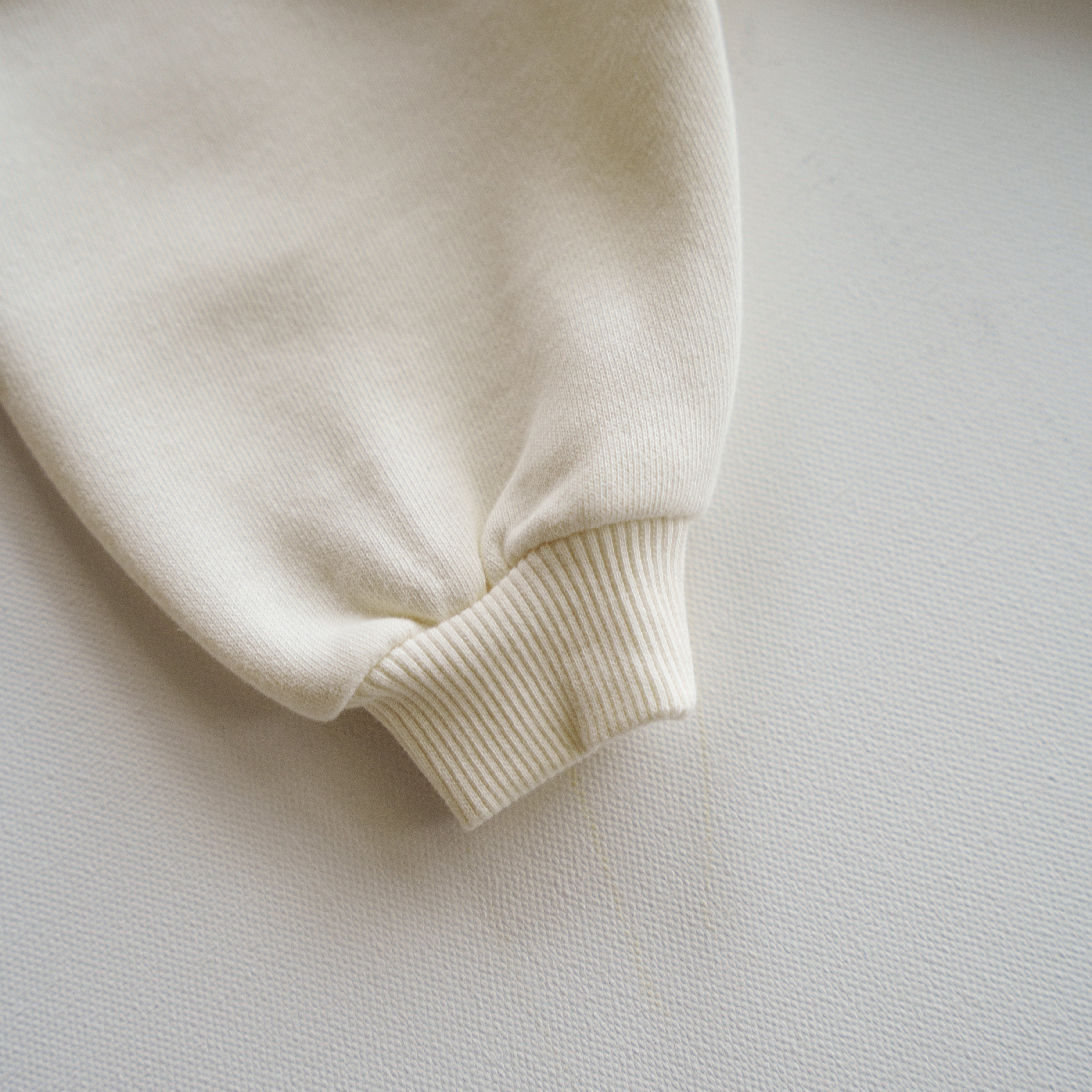 Close-up of the cuff of an Oversized Sweatpant in soft neutral fabric, perfect for babies and kids.