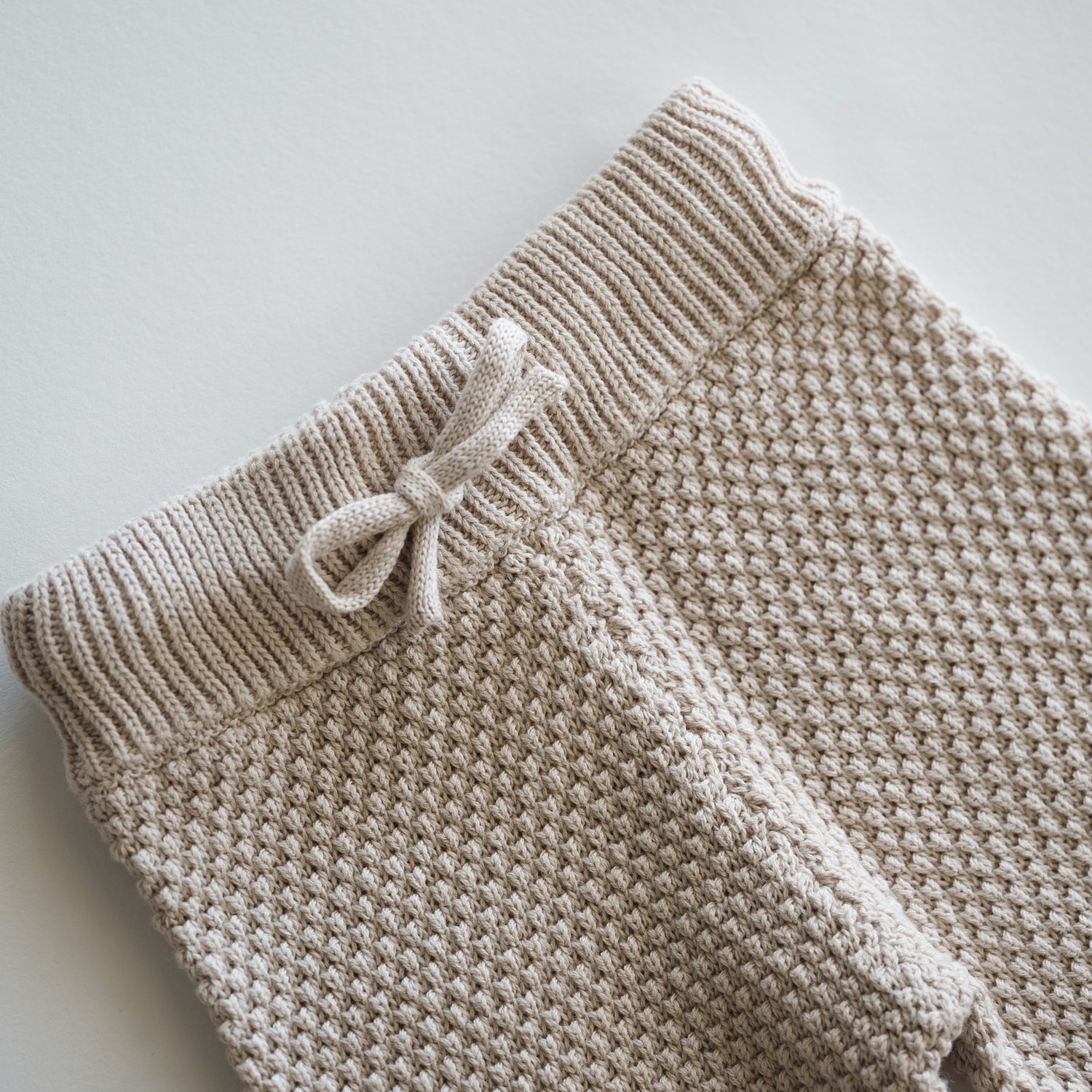 Organic Knit Wideleg Pant features a soft, breathable knit with a textured waistband and bow detail for baby comfort.