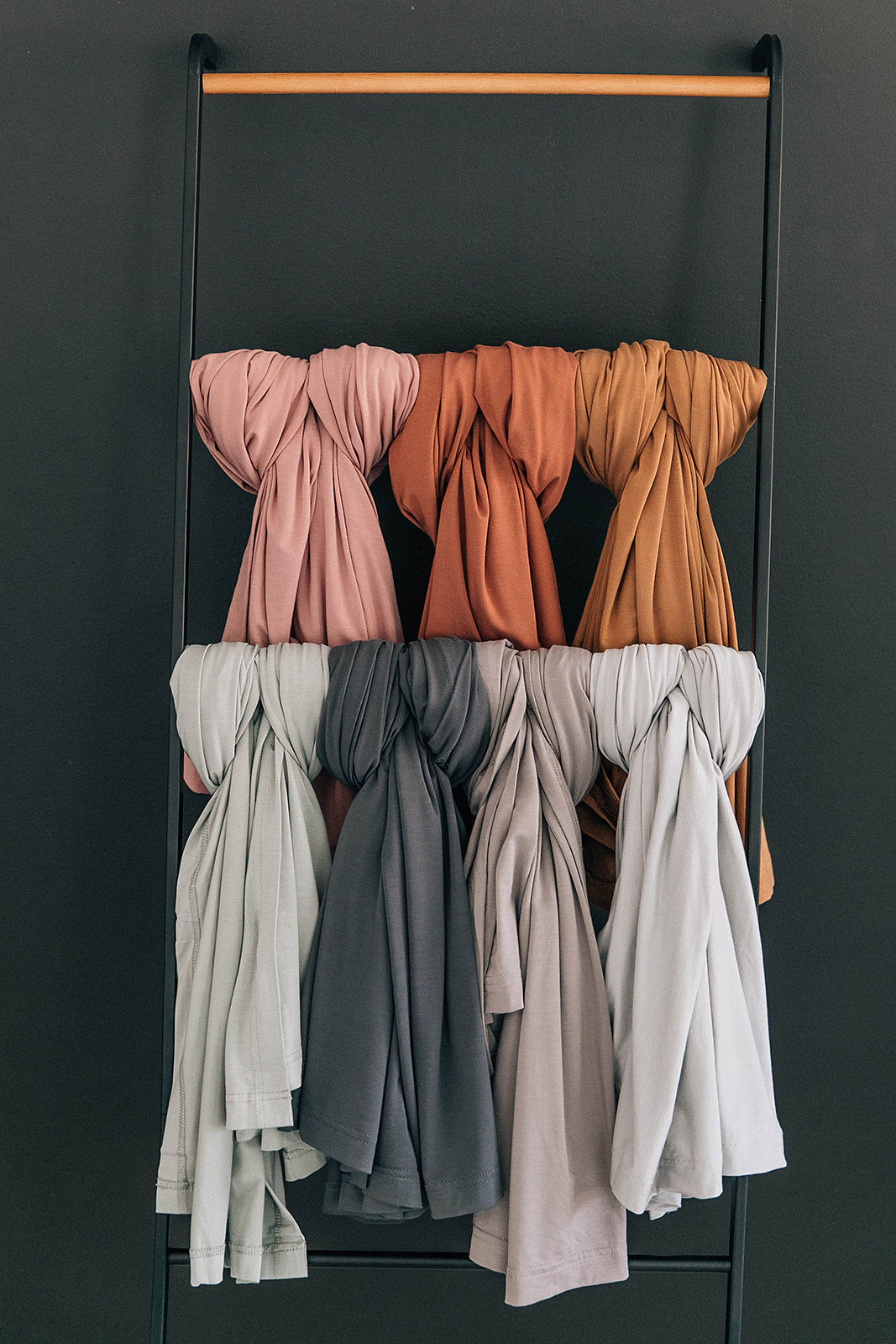 Bamboo Stretch Swaddle Sage collection in various calming colors on display, showcasing baby wrap options.