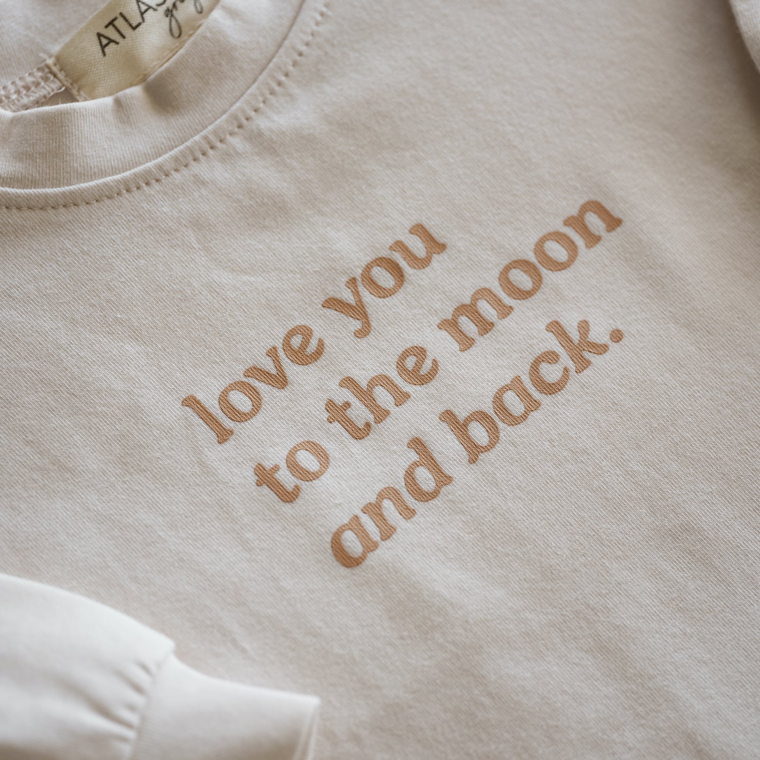 Love You to the Moon and Back Organic Longsleeve with a heartfelt message printed across the chest.