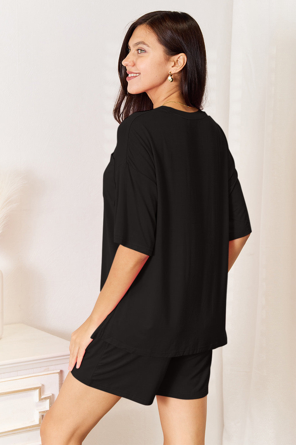 Model wearing a black Basic Bae soft rayon half sleeve top and shorts set, showcasing effortless everyday style.