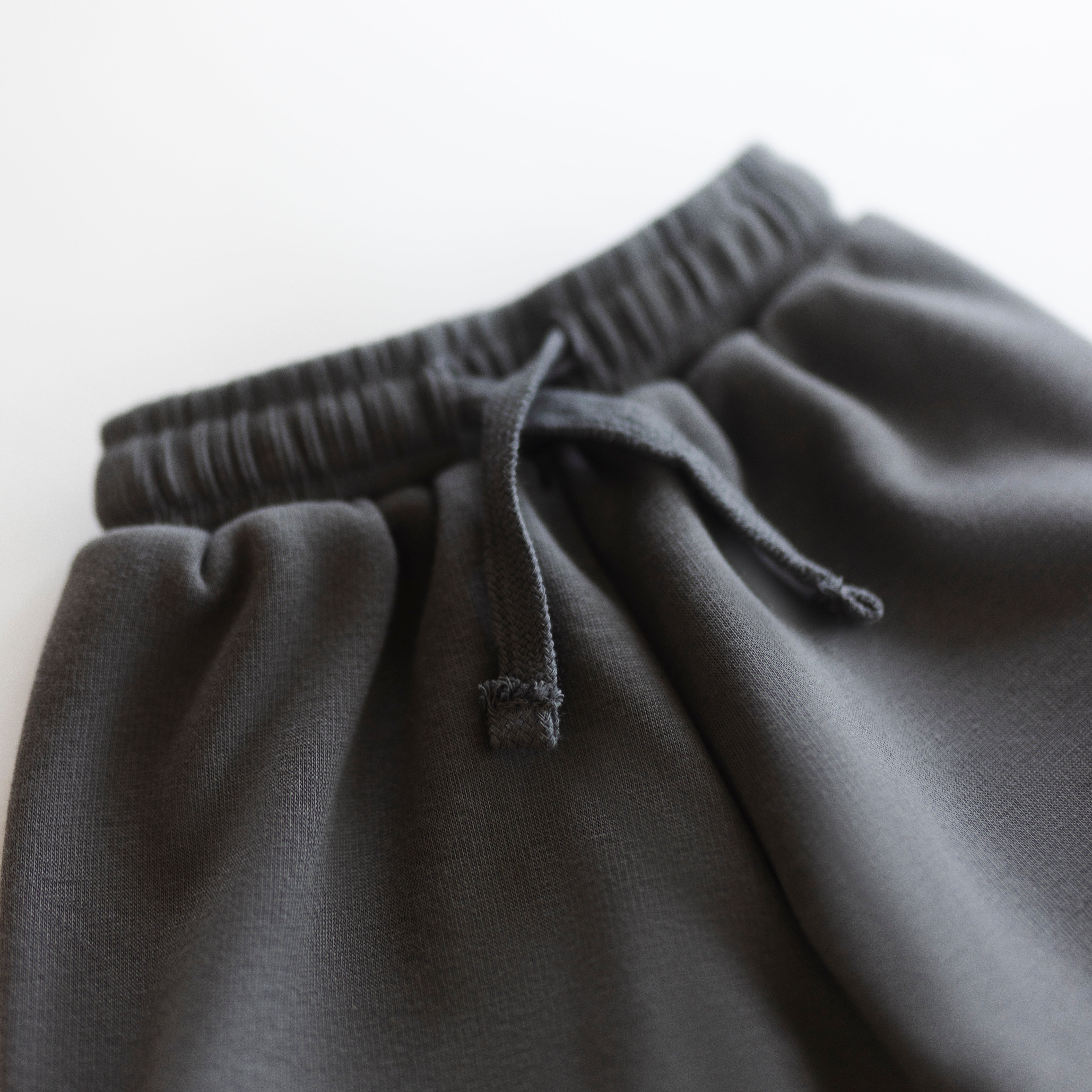Close-up of the waistband of an Oversized Sweatpant in cozy neutral fabric for babies and kids.