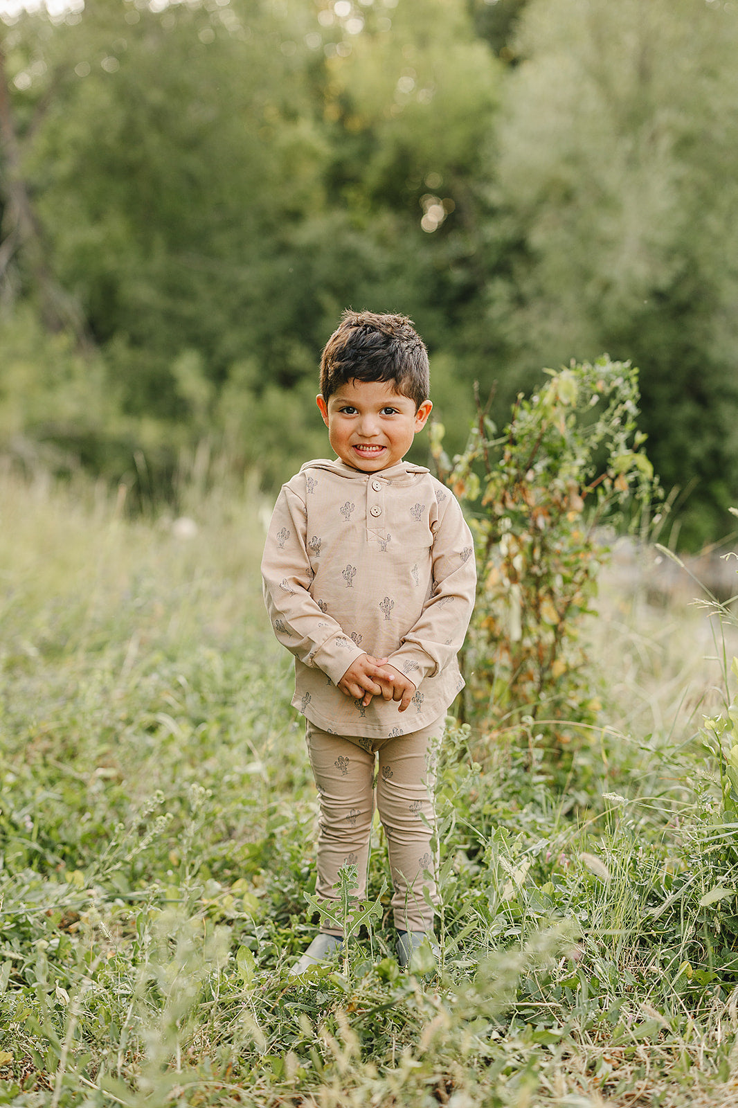 Cactus Hooded Set shown on a cheerful child outdoors, showcasing its playful cactus design in a natural setting.