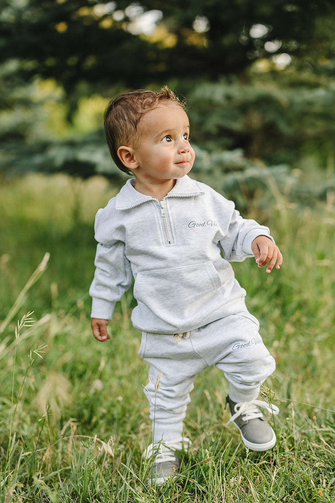 Toddler wearing unisex Good Vibes quarter zip French terry set in a grassy field, perfect for school and play.