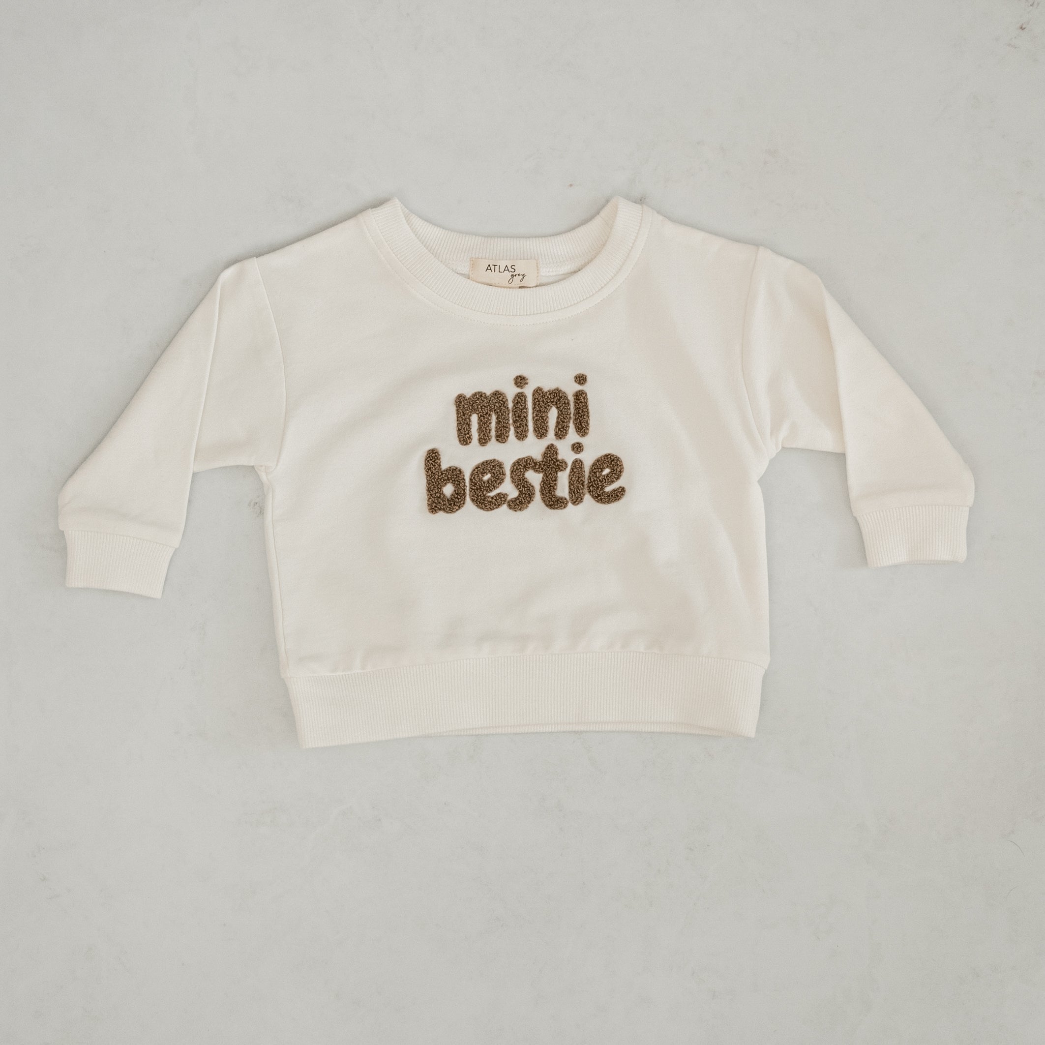 Mini Bestie Crewneck - Unisex Baby Sweatshirt in natural white with fuzzy terry-cloth embroidery.