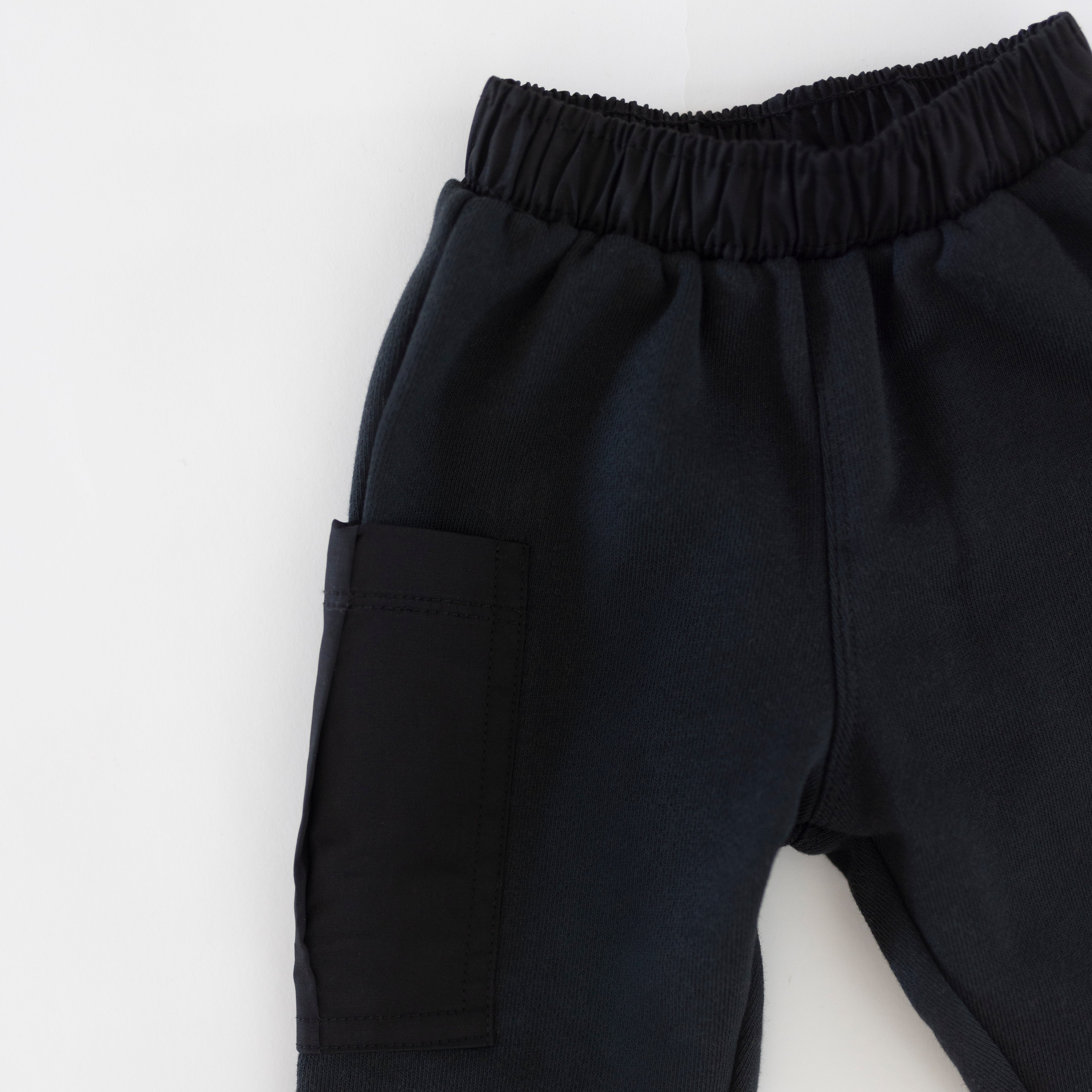 Cargo Wideleg Pant featuring an elastic waistband and cargo pocket in a soft dark color.