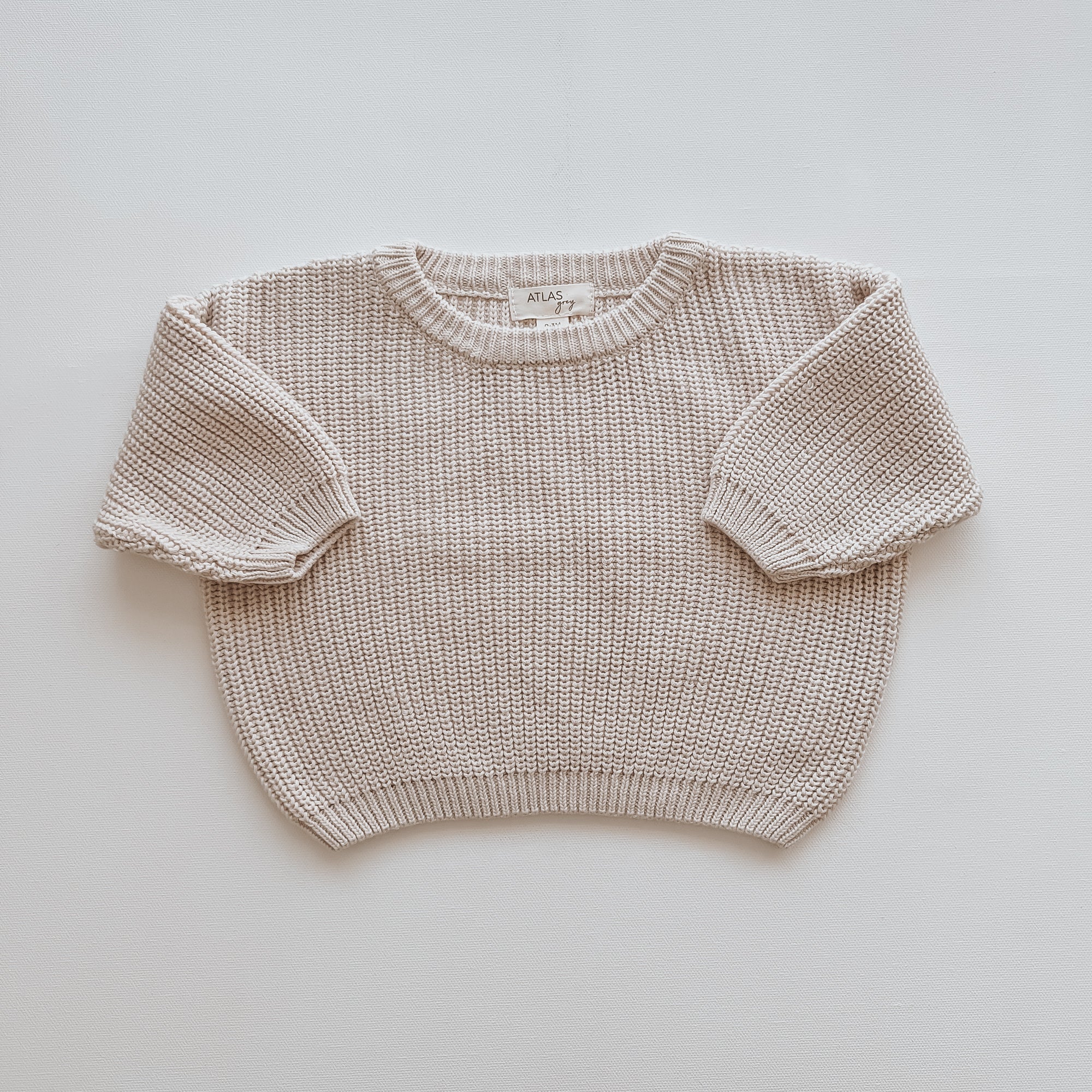Organic Chunky Knit Sweater in a soft beige hue, designed for babies and kids, made from 100% organic cotton.