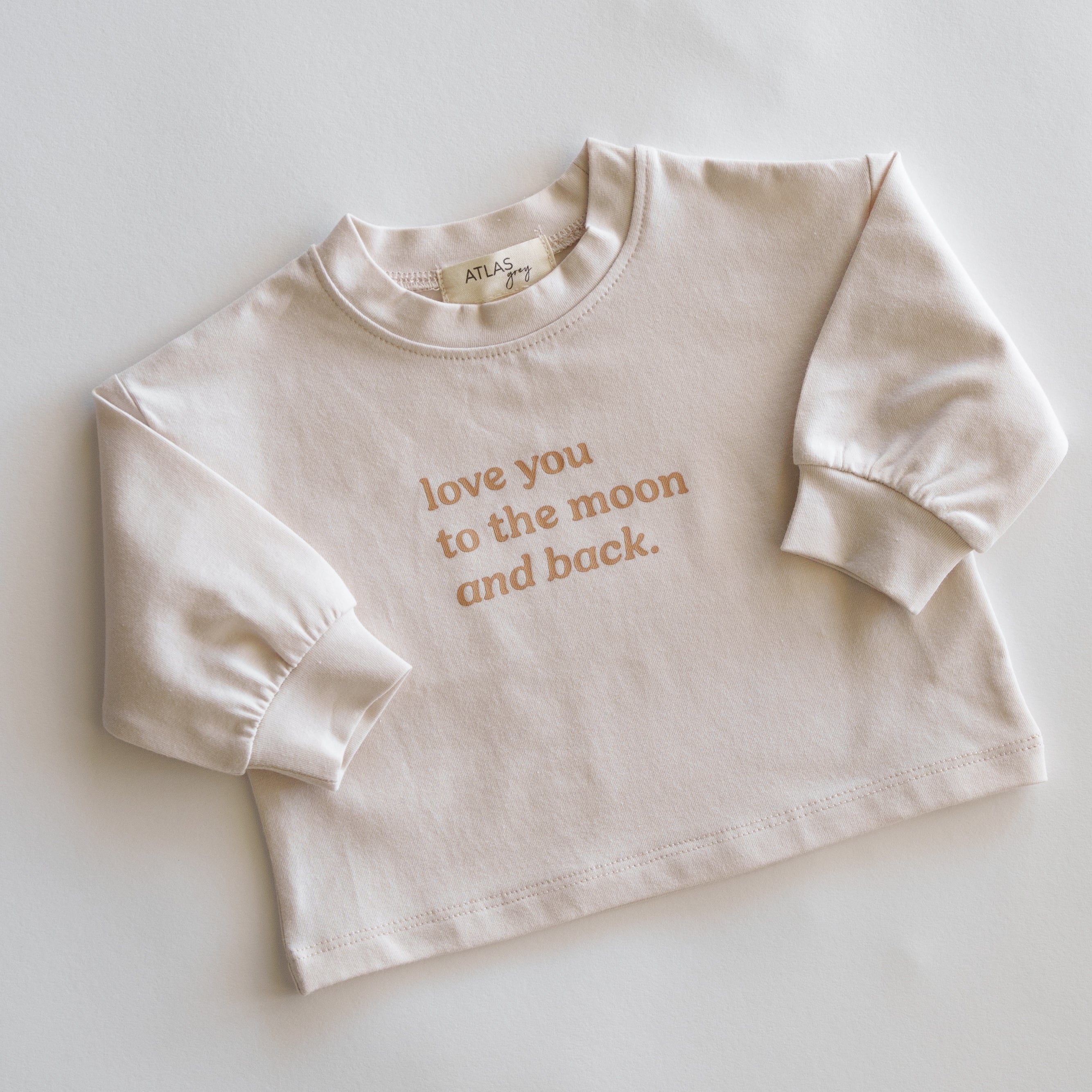 Love You to the Moon and Back Organic Longsleeve in soft cream featuring a heartfelt print.