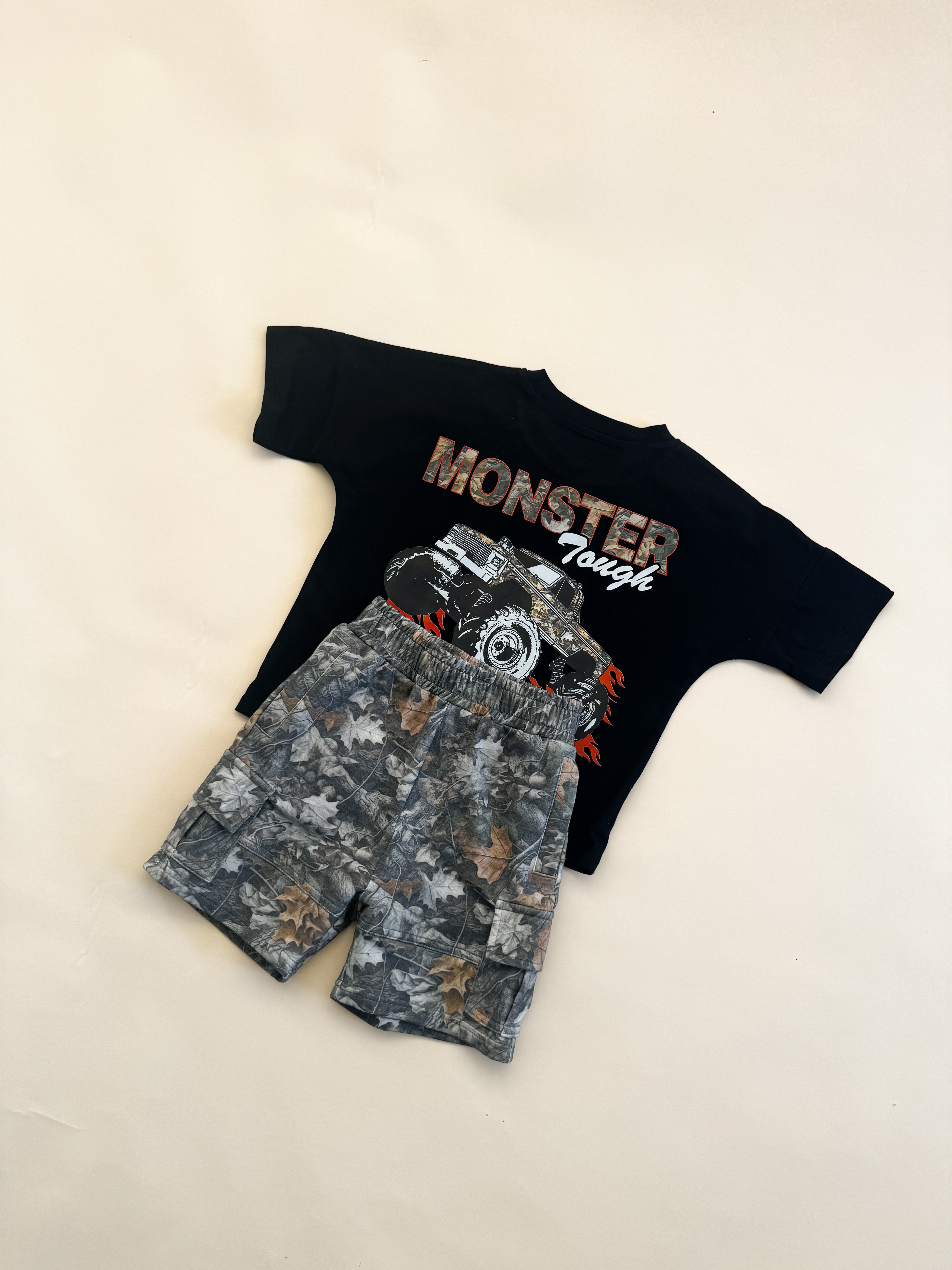 Black monster tough t-shirt with leaf camo cargo shorts for boys, perfect for play and outdoor adventures.