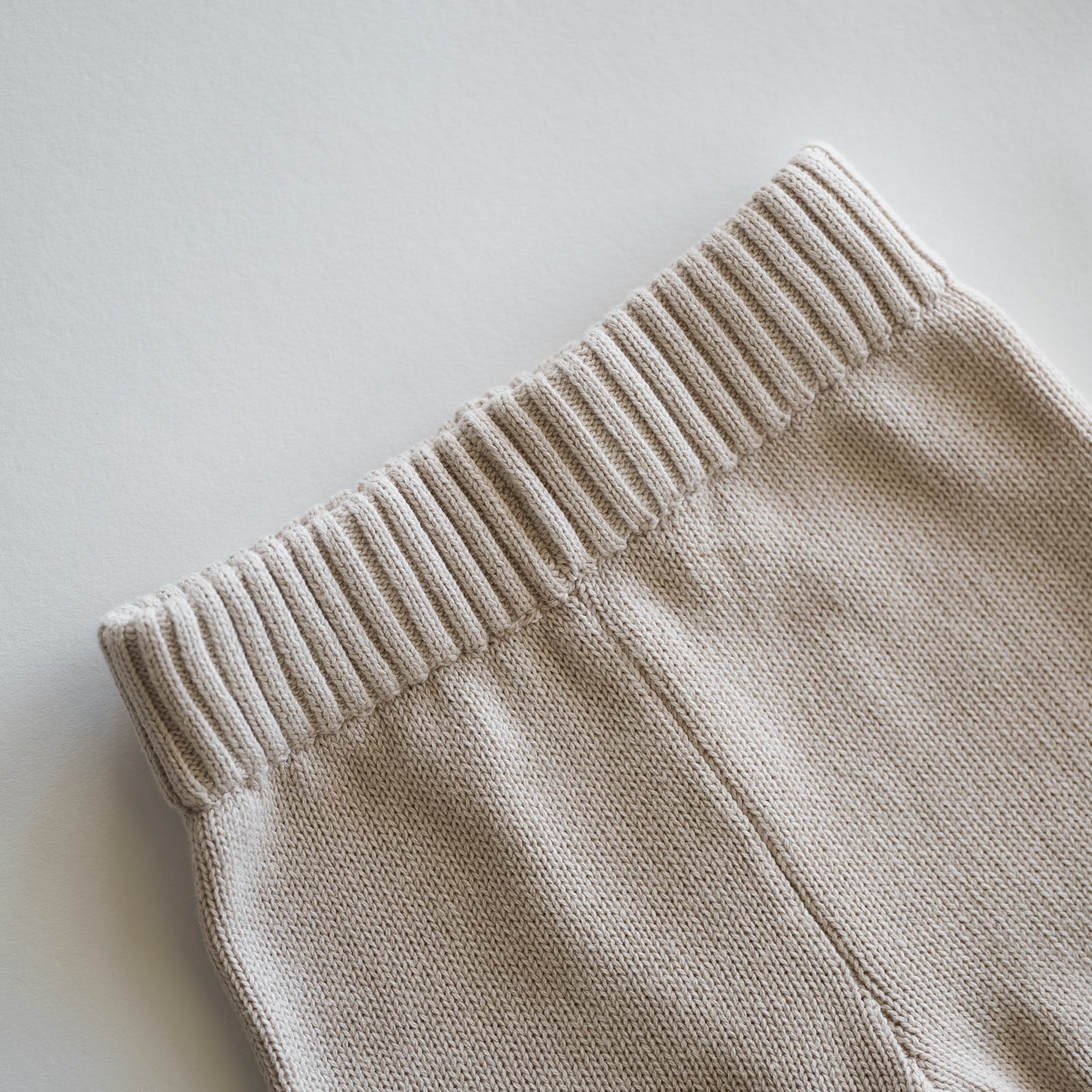 Close-up of the waistband of Organic Knit Oversized Pant in Ecru, showcasing softness and comfort for babies.