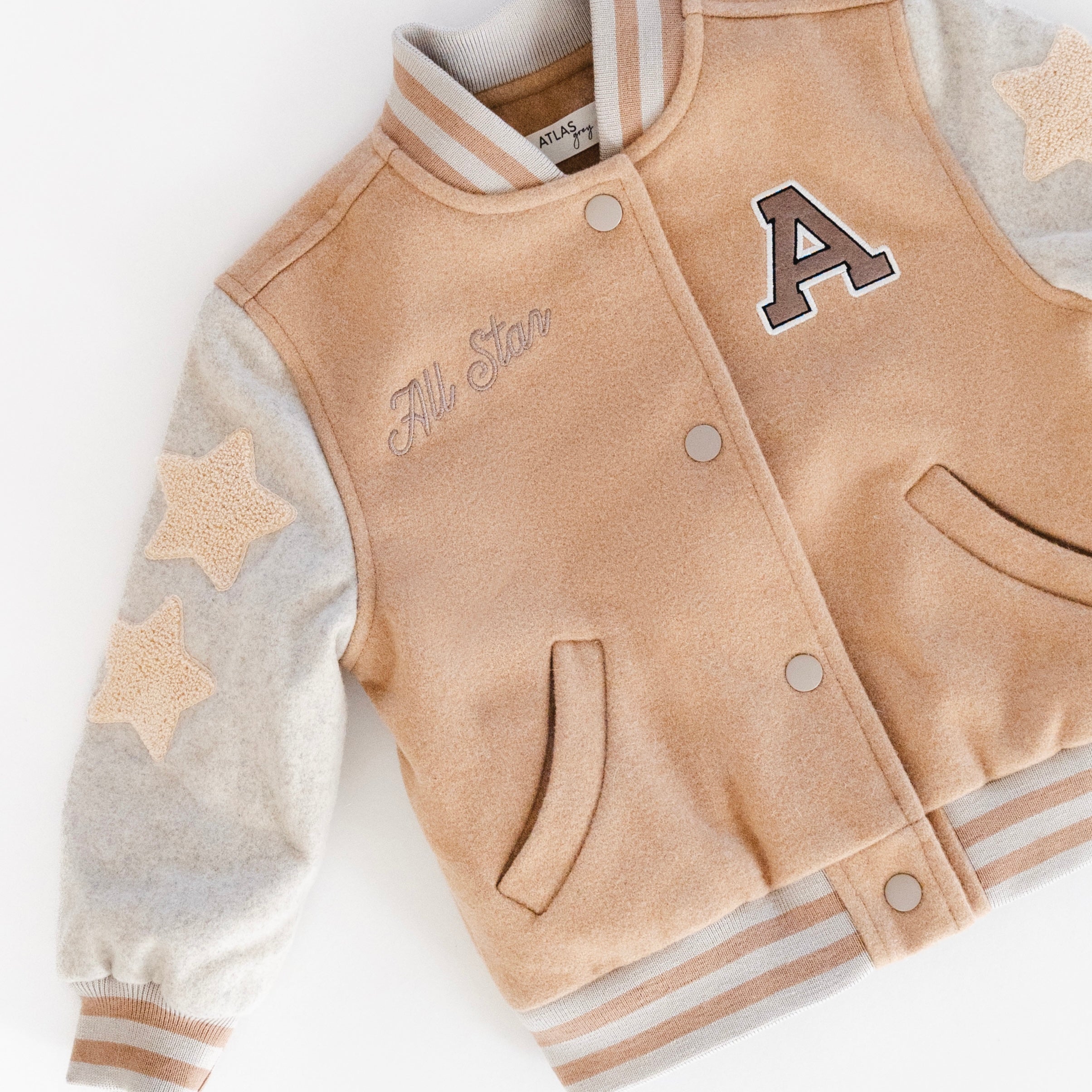 Letterman Jacket - Classic Varsity Outerwear for Kids featuring a tan body and gray sleeves with star design.