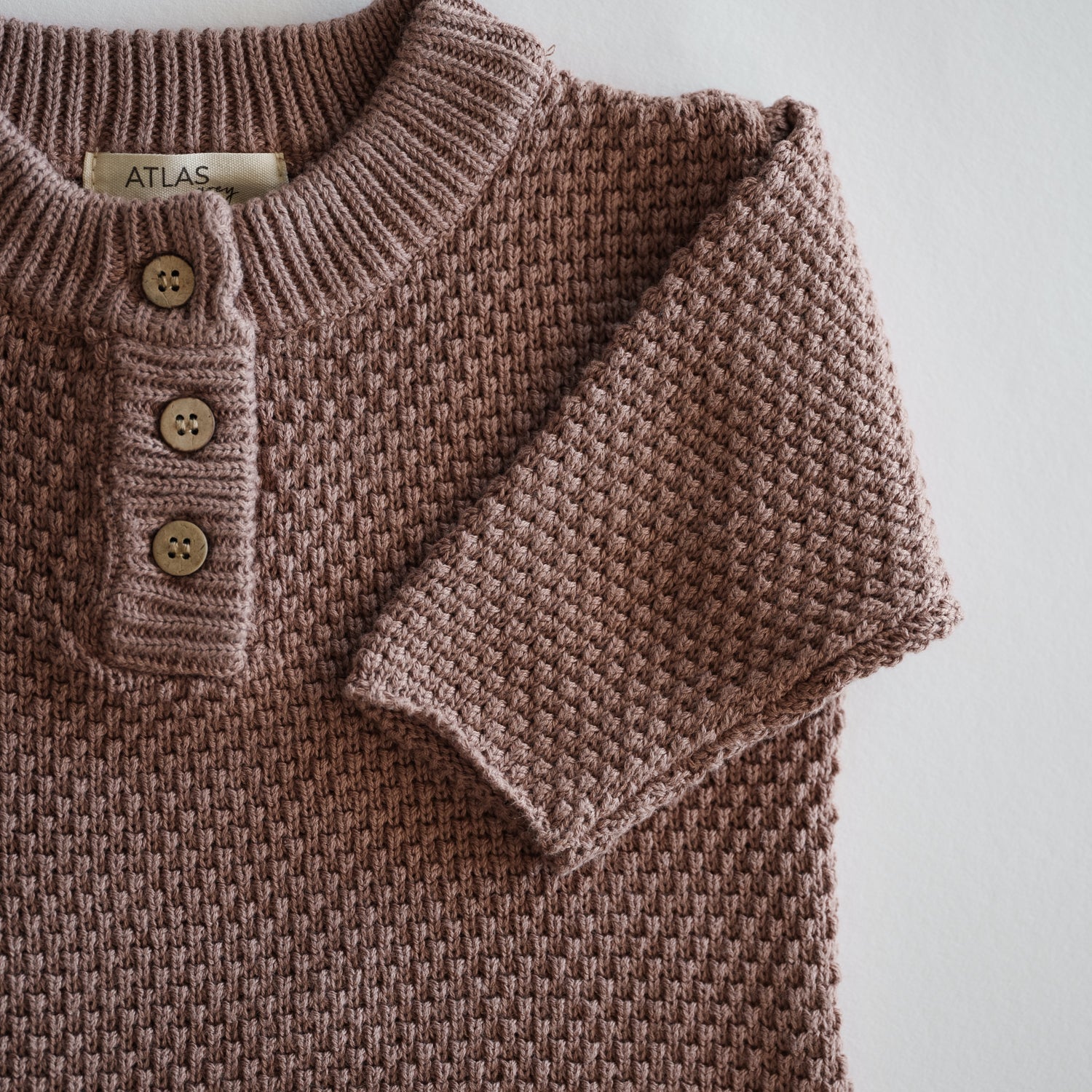 Organic Knit Baggy Longsleeve in warm neutral Brownie color featuring waffle knit texture and button details.