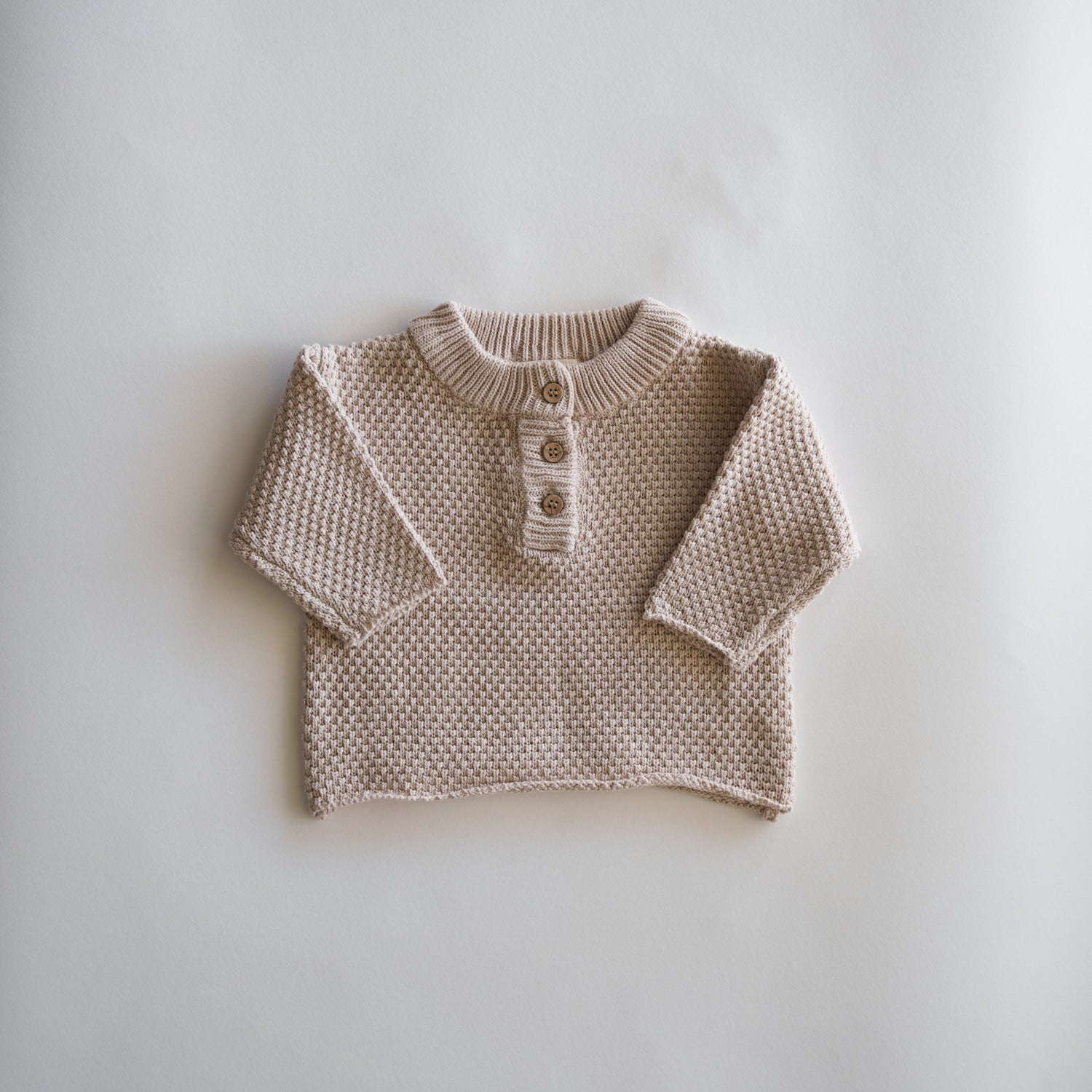 Organic Knit Baggy Longsleeve in a soft beige waffle knit design with button details for children.