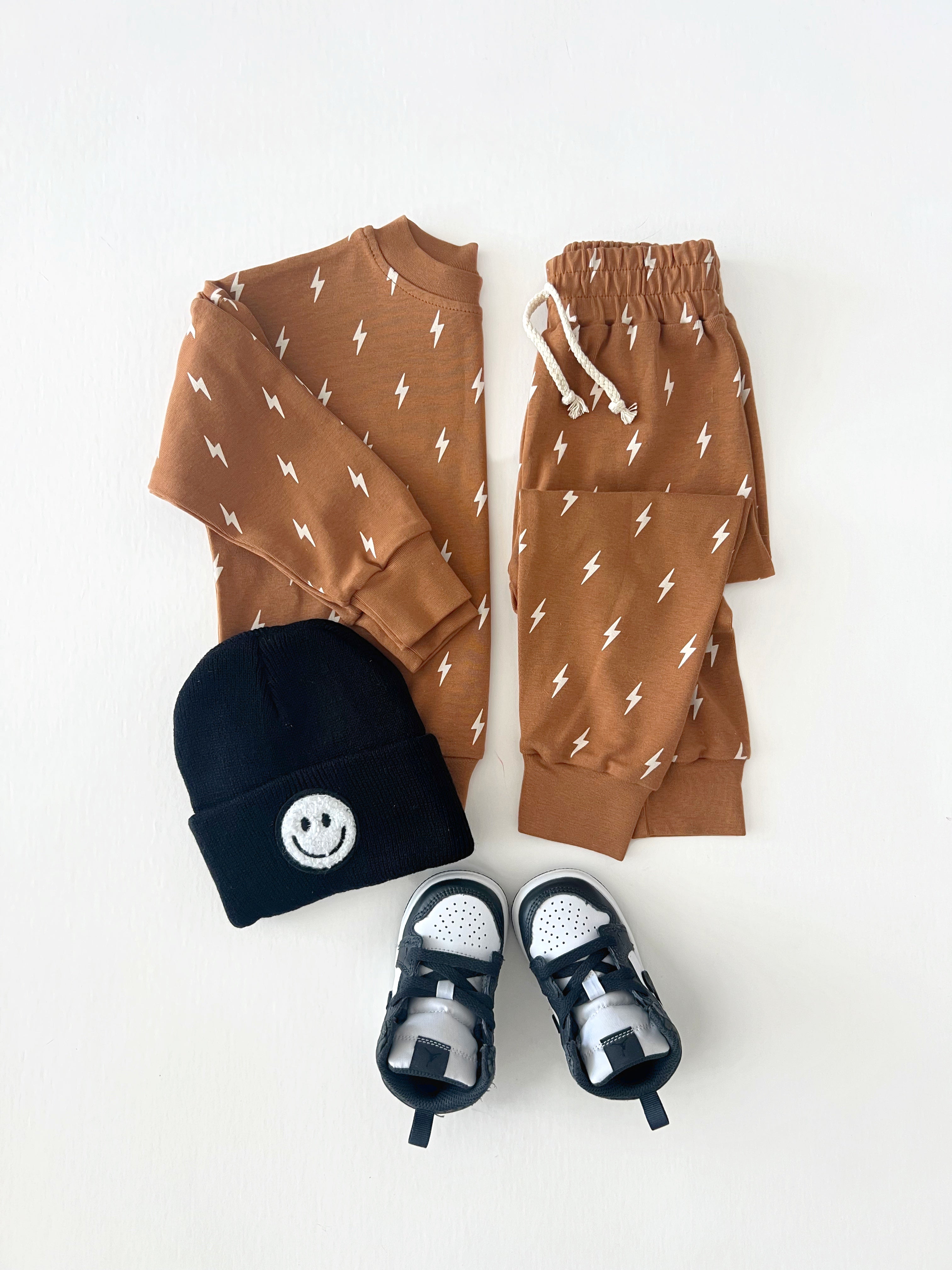 Fall Bolts Kids Lounge Set showcasing a pullover top, jogger bottoms, and accessories for babies and toddlers.