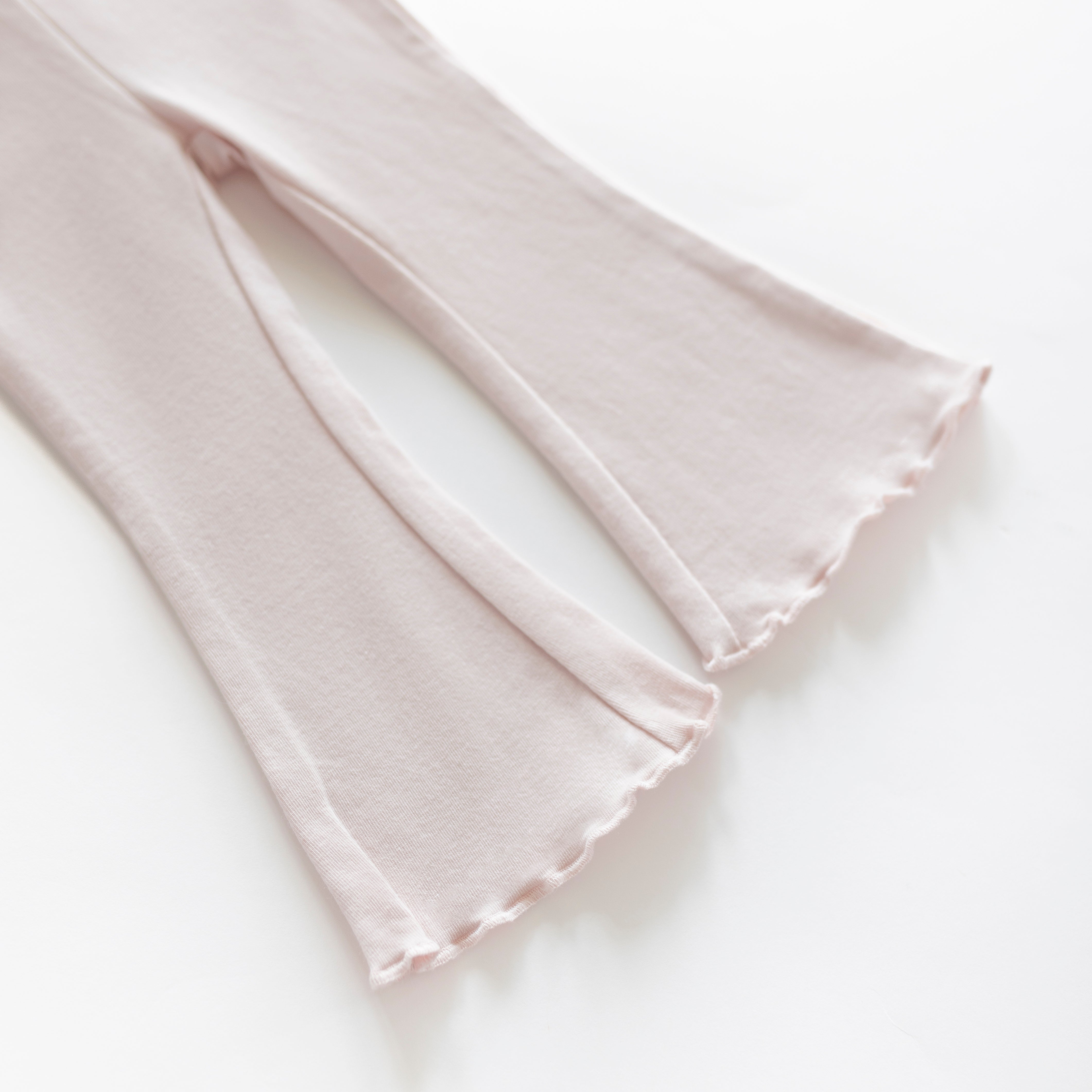 Cotton Flarepant in Pale Pink showcasing the playful flared hem perfect for babies and kids.