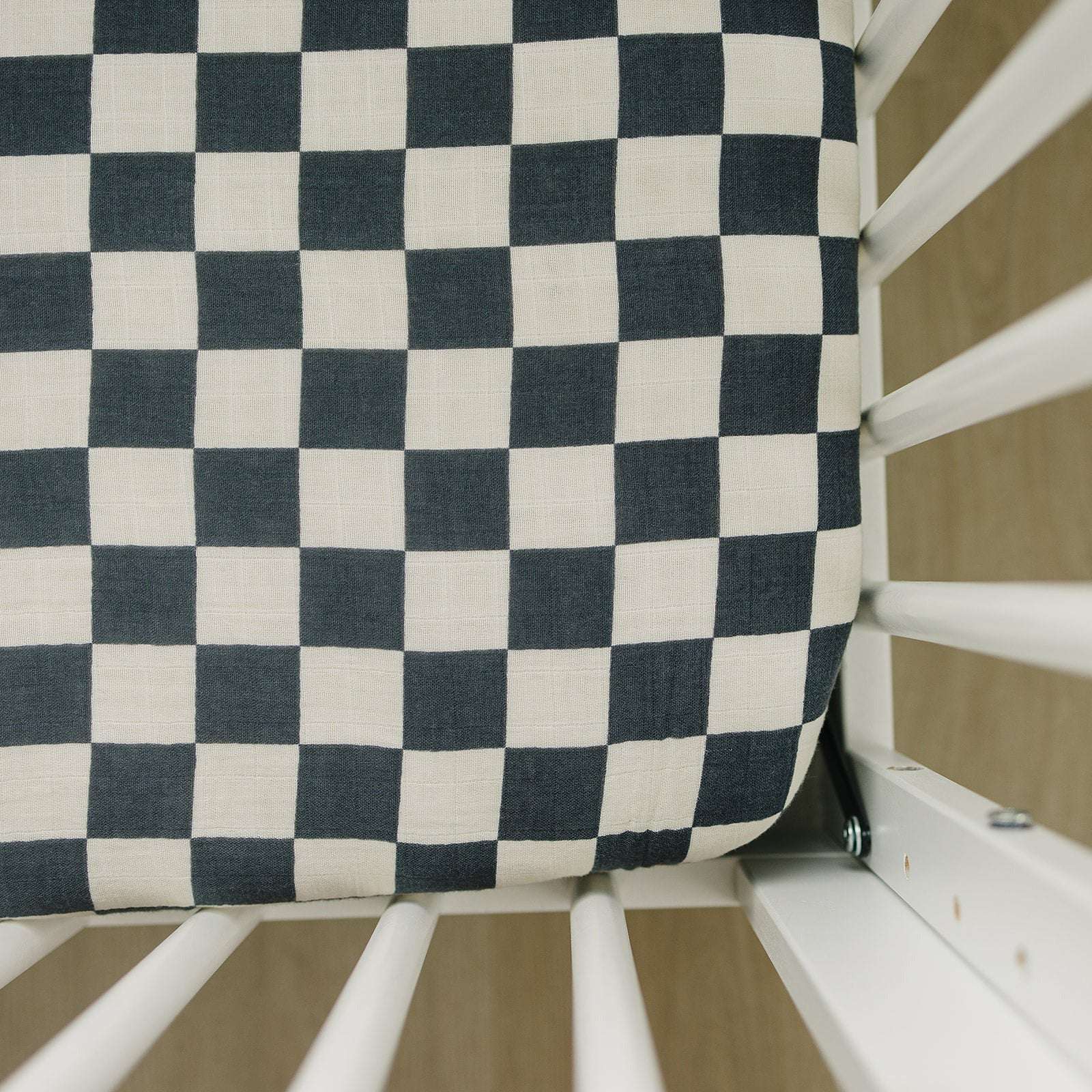 Muslin Crib Sheet - Charcoal Checkered on a crib mattress, designed for a cozy nursery look.