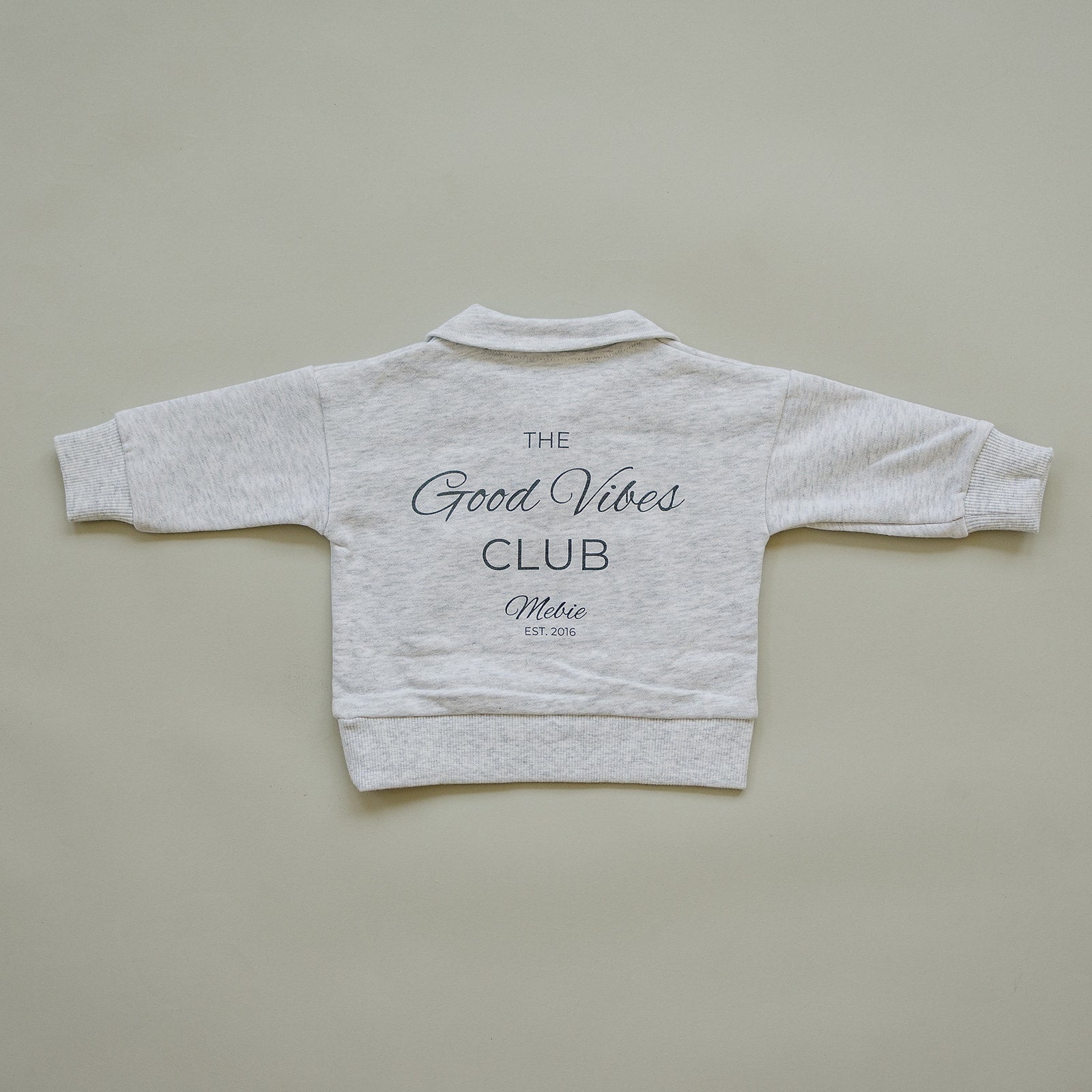 Back view of a gray unisex French terry sweatshirt featuring 'Good Vibes Club' in stylish lettering.