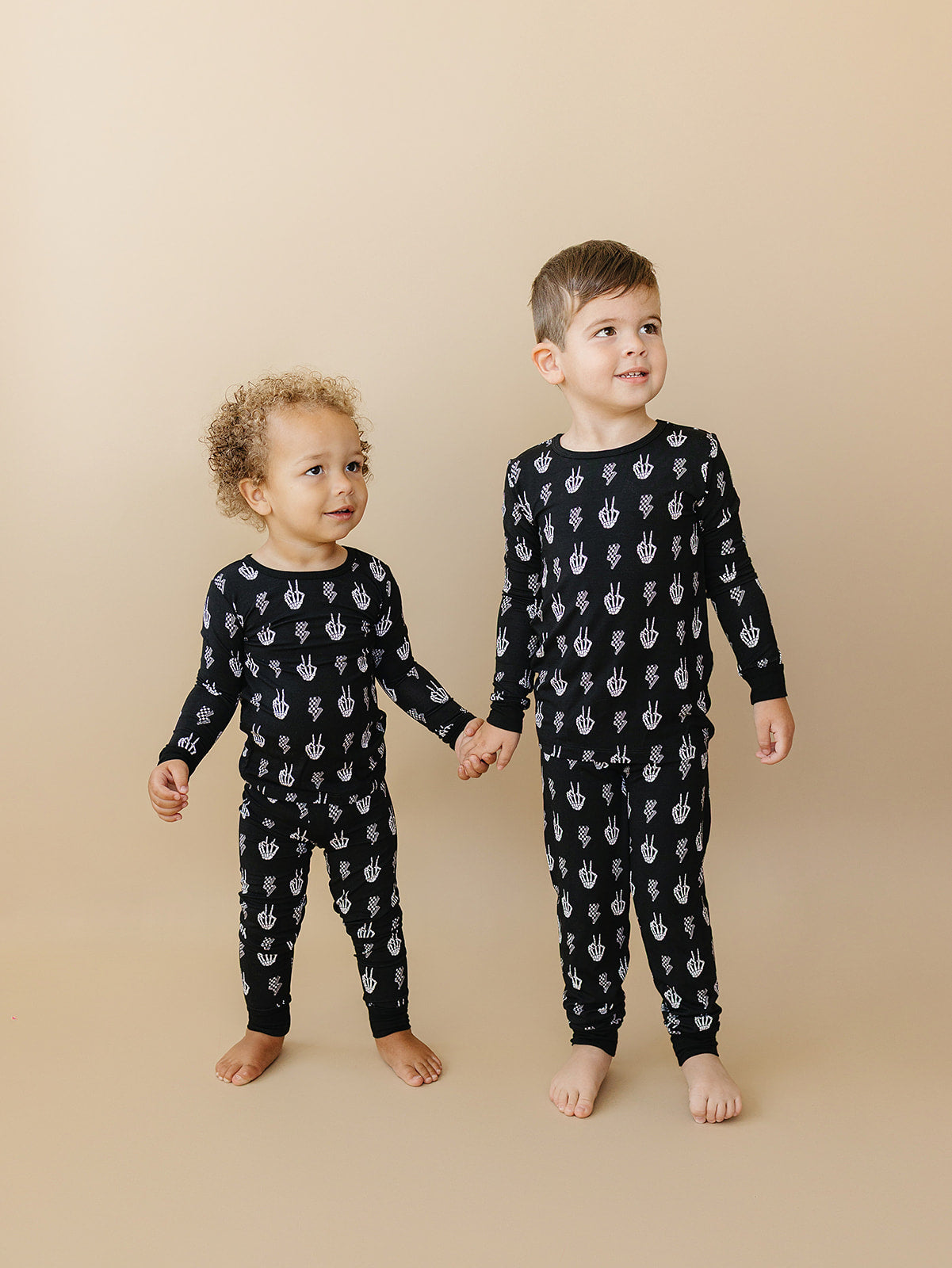 Kids wearing Bamboo Two-Piece Set Skelly Vibes with playful skeleton graphics, perfect for lounging.
