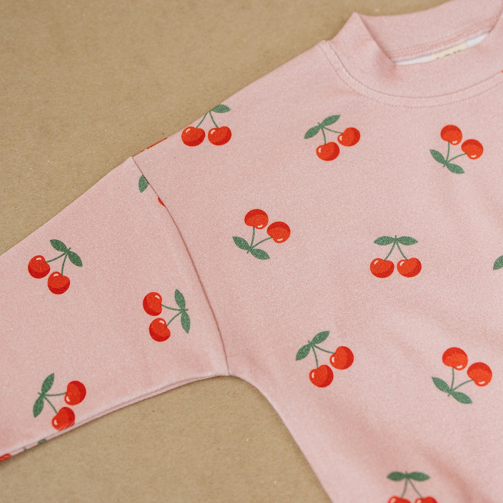 Blush Cherry Kids Lounge Set featuring a playful cherry print on a soft pink top for baby and toddler outfits.