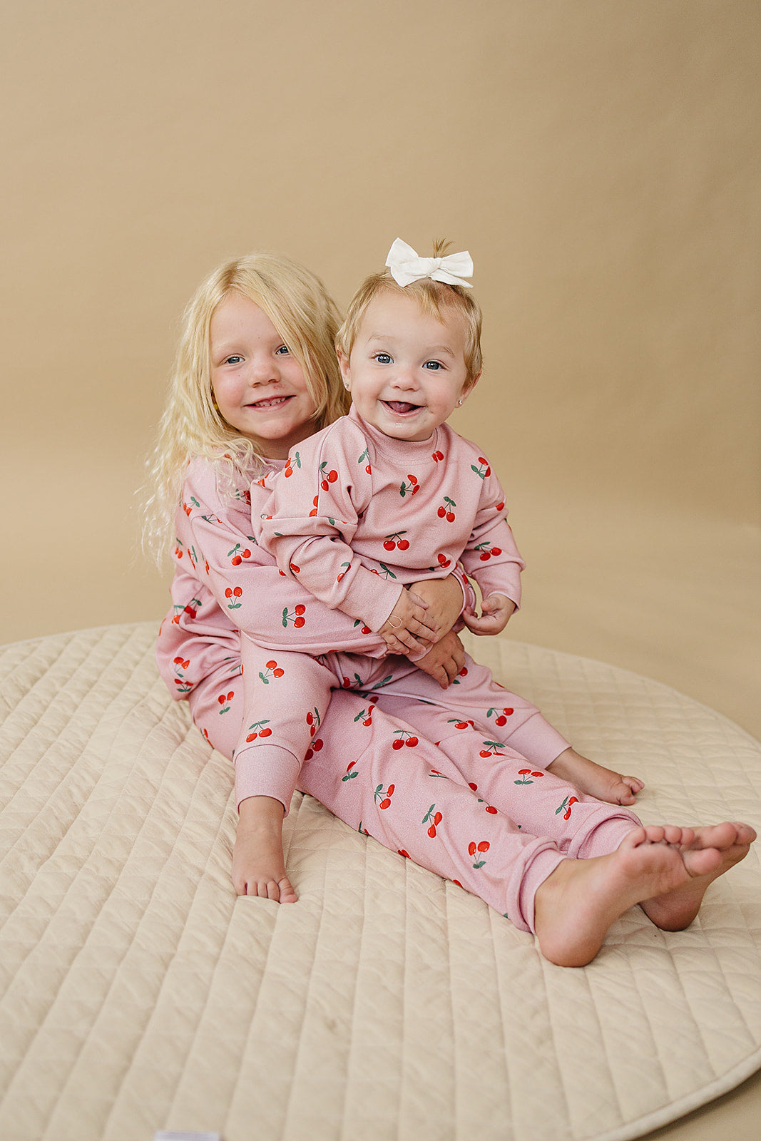Blush Cherry Kids Lounge Set - Baby & Toddler Outfit with joyful girls wearing cherry print lounge sets.