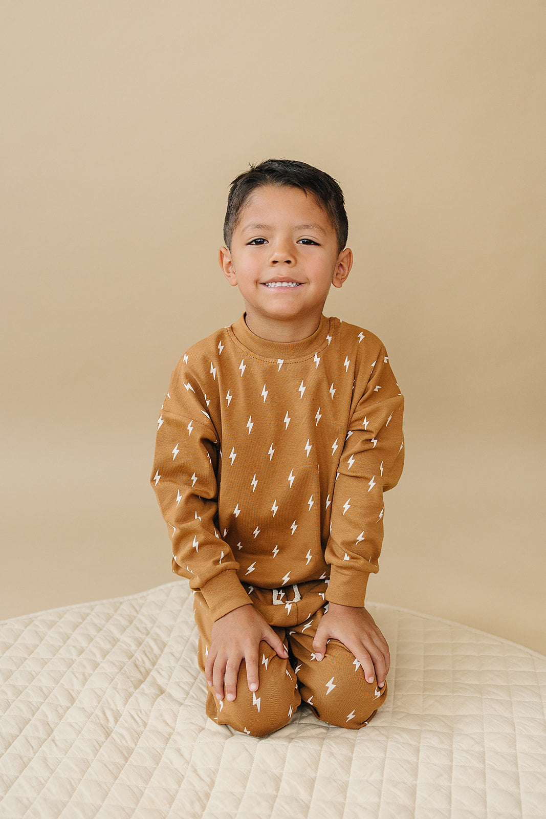 Fall Bolts Kids Lounge Set featuring a boy in a lightning bolt printed comfy outfit in earthy tones.