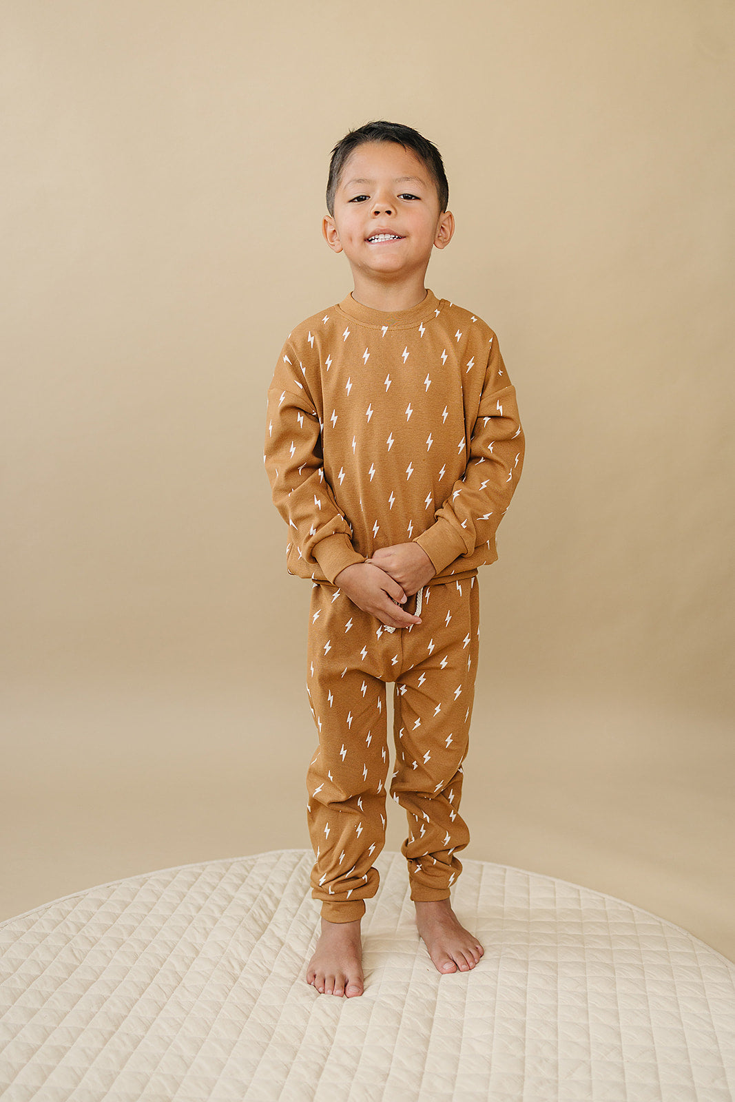 Fall Bolts Kids Lounge Set - Baby & Toddler Outfit featuring a boy in earthy tone pullover and jogger bottoms.