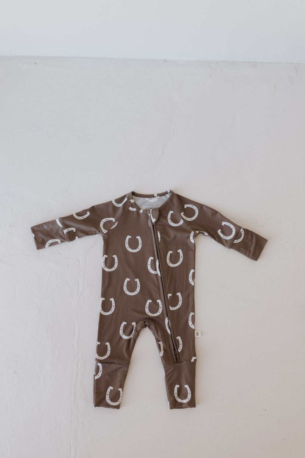 Bamboo zip pajamas with a playful horseshoe print in brown for toddlers, ideal for cozy sleepwear.
