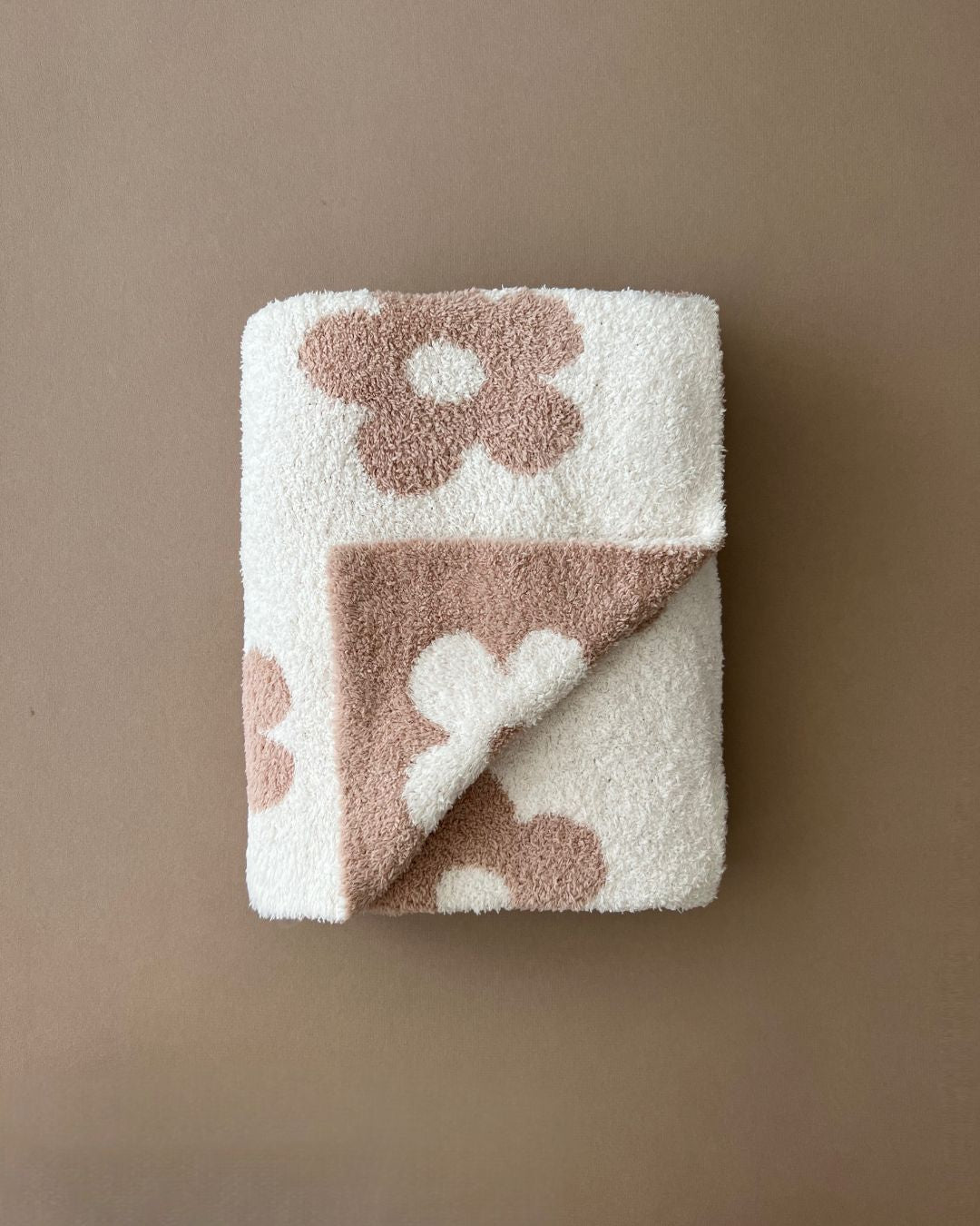 Daisy Fuzzy Blanket in latte featuring a floral design, made from soft, plush material for cozy comfort.