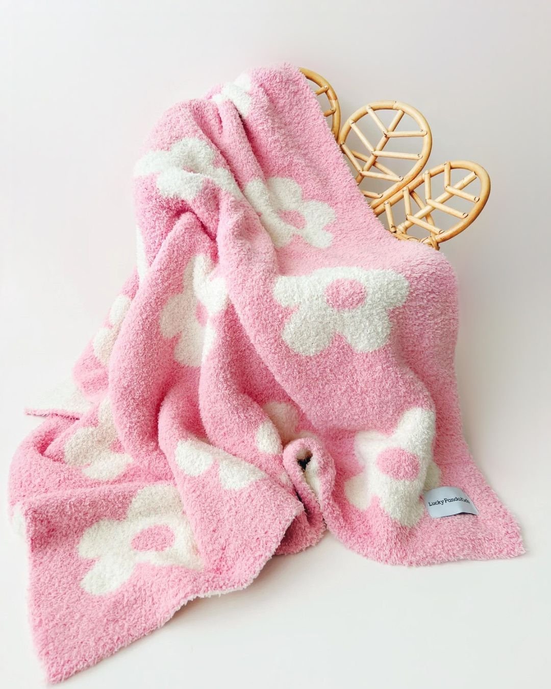 Daisy Fuzzy Blanket in pink with white flowers, soft and cozy for children, perfect for cuddles and stroller rides.