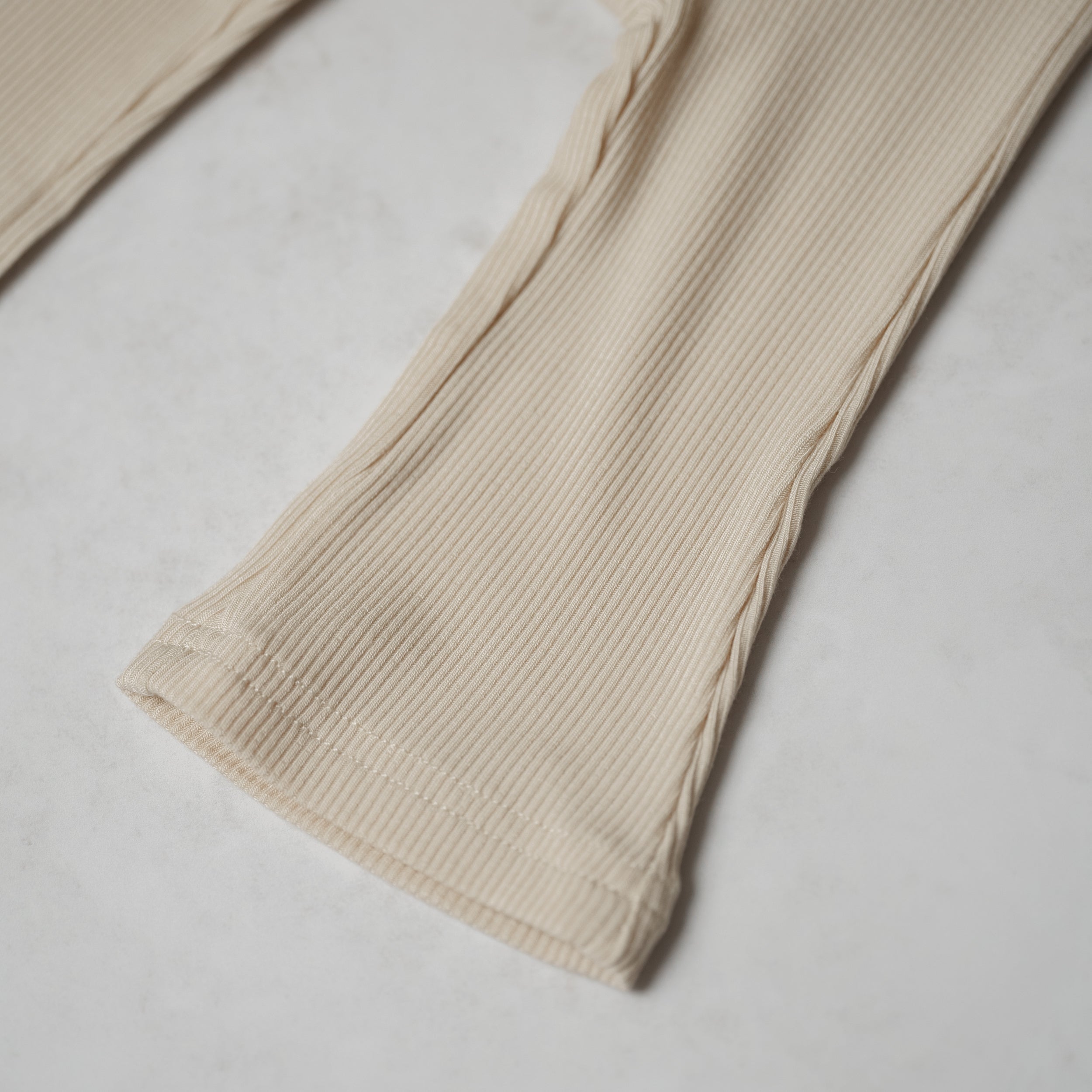 Ribbed Modal Flare Pant - close-up of soft ribbed texture and neutral color
