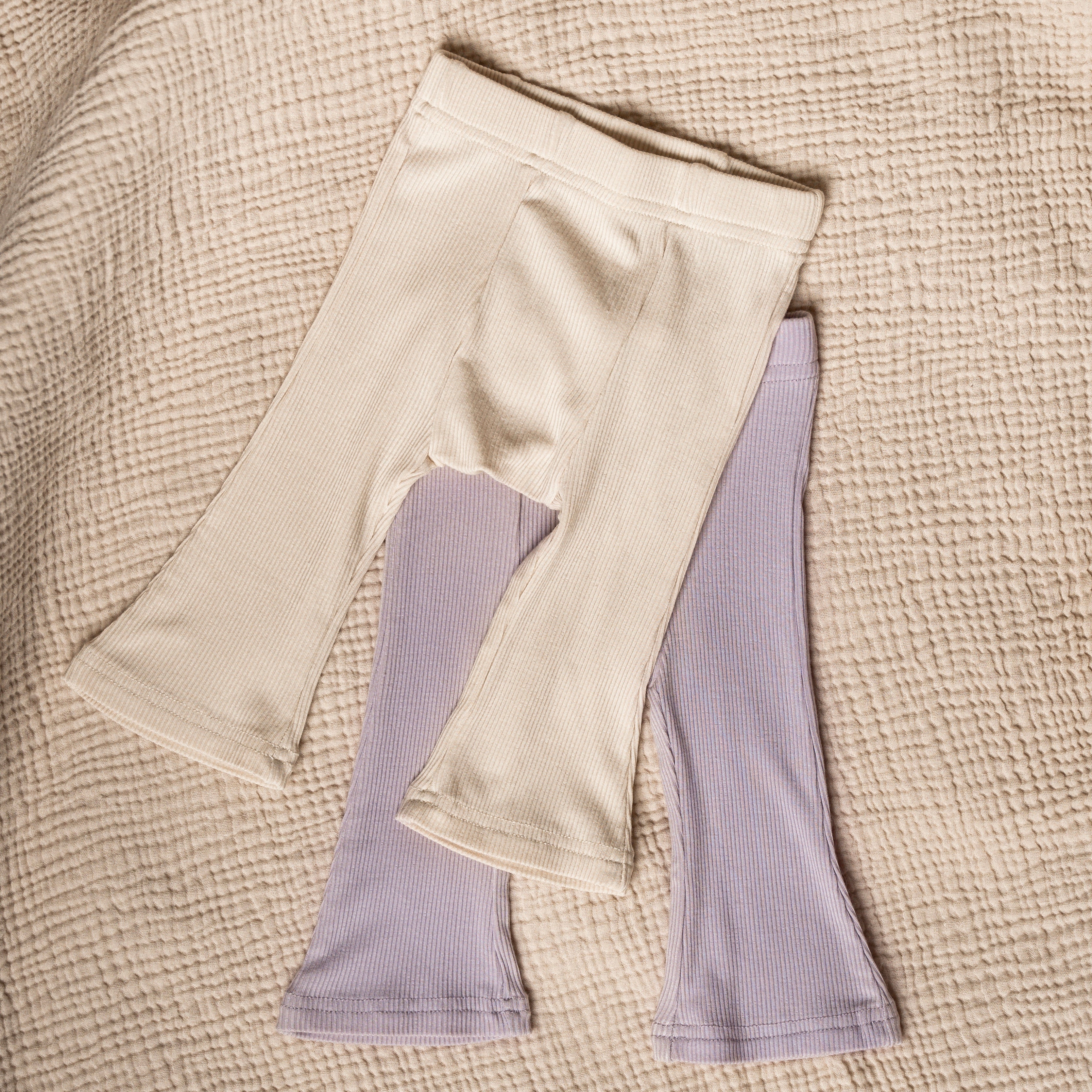 Ribbed Modal Flare Pant in neutral colors, showcasing soft ribbed texture and stylish flare design.