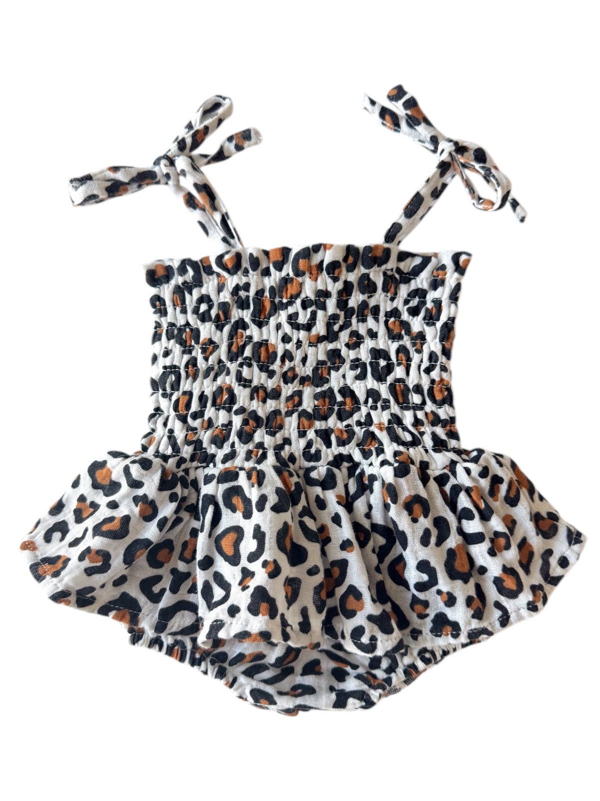 Leopard baby bubble romper with skirt overlay, smocked design, and adjustable ties for toddlers.